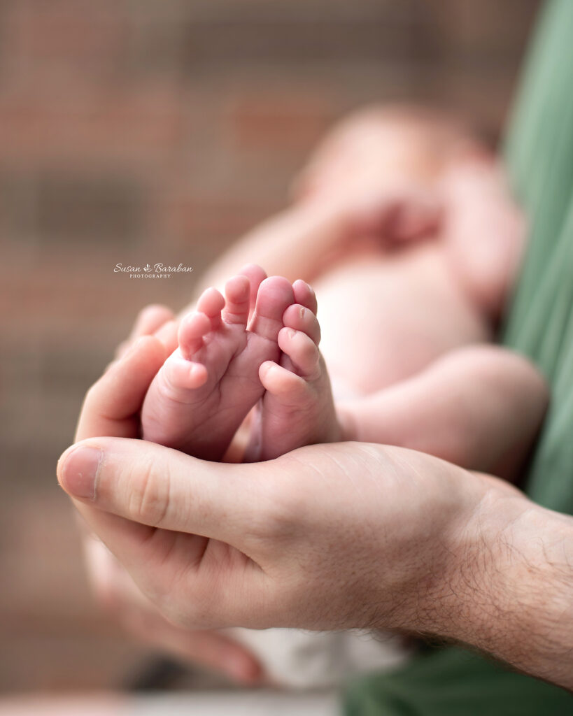Close up detail image of newborn feet during a newborn photo session in Allen, TX with Susan Baraban Photography.